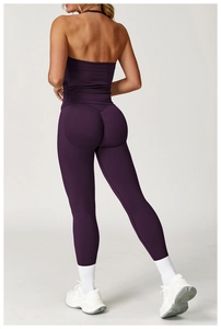 Detail view of seamless dark purple yoga set with ruched sports top and high-waisted leggings