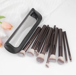 Close-up of 13-piece makeup brush set with brown handles in a transparent storage bag