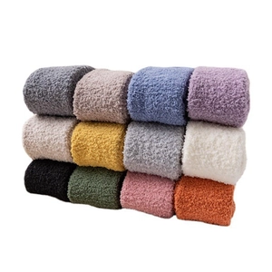 Thick coral fleece over-knee socks in multiple colors stacked neatly on white background