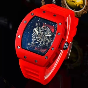 Detailed macro shot of skeleton dial and red silicone strap on tonneau mechanical watch