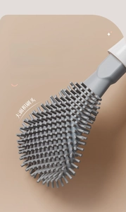 Detail of grey silicone toilet brush head with curved design for deep corner cleaning