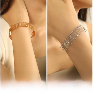 Close-up of layered open cuff bracelet with rope texture and tiny white pearls detail