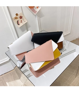 Detail of geometric patchwork flap bags with contrast stitching and high-quality PU leather