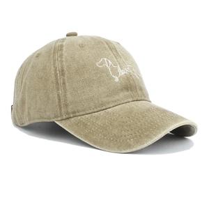 Close-up of dachshund and love embroidery on washed khaki cotton baseball cap