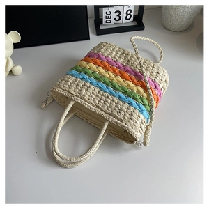 Close-up of rainbow striped straw bag with woven rope texture and drawstring closure
