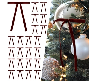 Detail of deep red velvet Christmas tree bows showing texture and decorative application