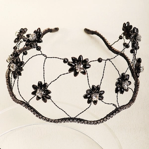 Detailed view of black floral crystal beads and woven wire mesh on a bridal headband