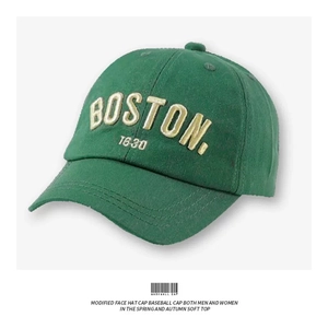 Detailed close-up of dark green vintage baseball cap featuring premium Boston embroidery