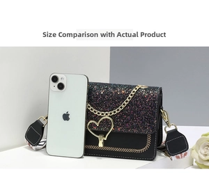 Detail of black crossbody bag with sequined flap, golden heart lock and colorful strap