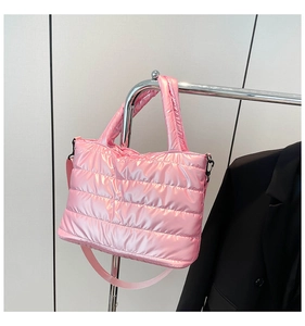 Detail of pink quilted puffer tote bag with glossy finish and detachable shoulder strap