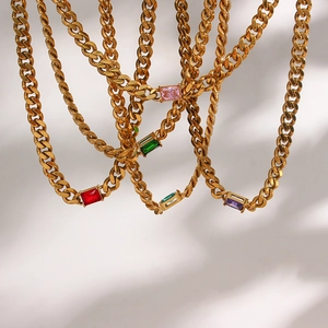 Detail of 6.5mm gold Cuban link chains with vibrant rectangular zircon pendants