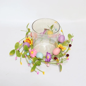 Detail view of Easter candle ring with pastel artificial daisies and colorful eggs