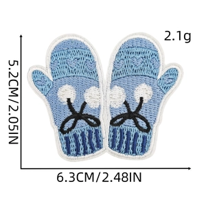 Detail of light blue embroidered mitten patch with white pom-pom and heart, 6.3x5.2cm