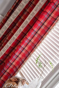 Detailed red plaid curtain with beige lace stitching and fringe pompom ball trim