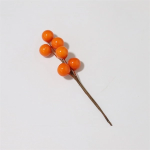 Detail shot of bright orange artificial berry stems for festive home decor and DIY crafts