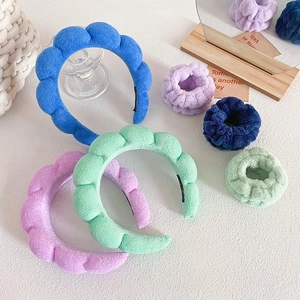 Puffy sponge headband and wristband set in vibrant plush fleece for skincare and makeup