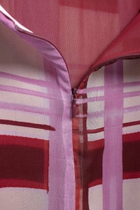 Detail of invisible zipper on purple plaid skirt with high-quality stitching