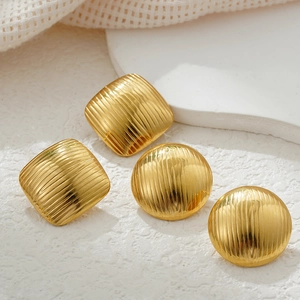 Detail of 18k gold plated stainless steel hoop earrings with vertical stripe texture