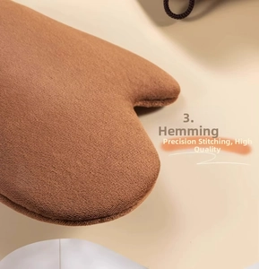 Detail shot of brown plush tanning mitt showing high-quality stitching and soft texture