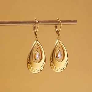 Detail of 18k gold plated water drop earrings with hammer texture and zircon stones