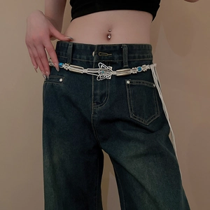 Detail of bohemian waist chain featuring blue beads and silver butterfly buckle