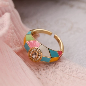 Detail of 18K gold plated ring with colorful enamel inlay and oval zircon center stone
