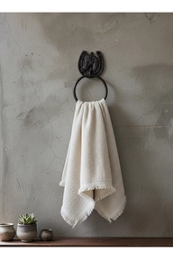 Industrial vintage cast iron horse head towel ring with waffle textured towel on wall