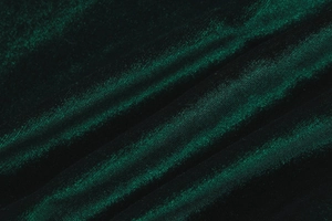 Detailed close-up of premium dark green velvet fabric with soft folds and elegant sheen