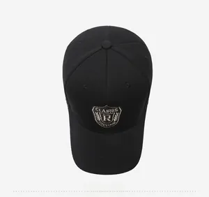 Top view of black baseball cap with detailed embroidered shield badge and woven texture