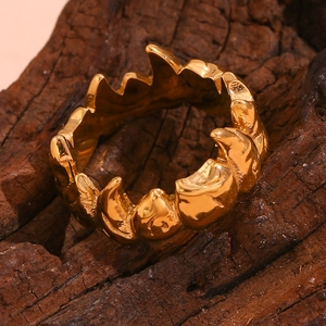 Macro shot of gold-plated stainless steel ring with vintage irregular rock texture