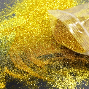 Detailed macro view of 0.2mm champagne gold nail glitter powder in a clear bag