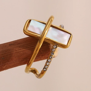 Macro detail of 18K gold plated double-layer ring with mother of pearl and crystals