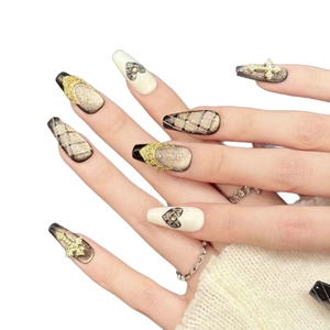 Handmade press-on nails with black cat eye design, gold crosses, and heart patterns