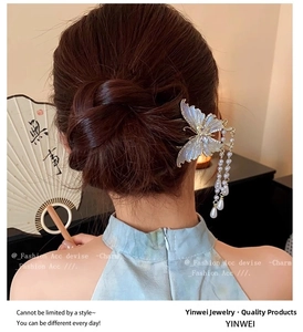 Detail of elegant butterfly hair clip with pearl tassels on a Chinese-style bun