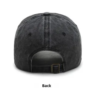 Detail view of washed black baseball cap with adjustable bronze metal buckle and denim texture