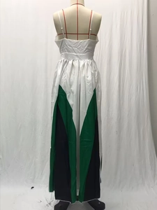 Close-up of color-block pleated maxi dress with geometric green and black pattern