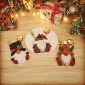Set of three Christmas gnome cutlery holders with festive red, black, and brown patterns