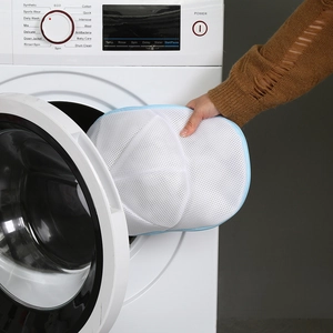 Placing a cap laundry bag into a washing machine to prevent deformation during wash