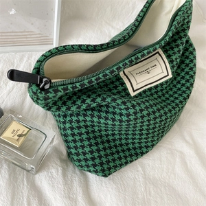 Macro detail of houndstooth fabric makeup bag with zipper and Pleasant Time label