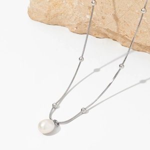 Elegant silver pearl pendant necklace with snake chain for a minimalist aesthetic