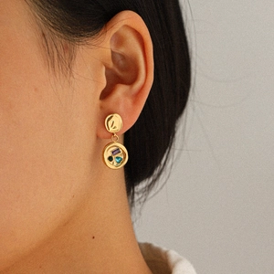 Geometric gold-plated stainless steel earrings with colorful enamel on female model