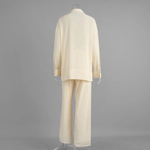 Back view of beige linen-blend shirt and trousers set showing fabric texture and fit