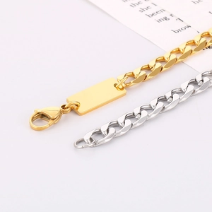 Close-up of gold and silver cuban link chains with rectangle identity tags and lobster clasps
