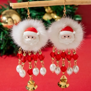 Close-up of Santa Claus beaded tassel earrings with white plush trim and golden bells