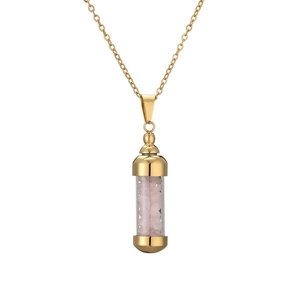 Detail of golden perfume bottle pendant necklace filled with pink crushed stones