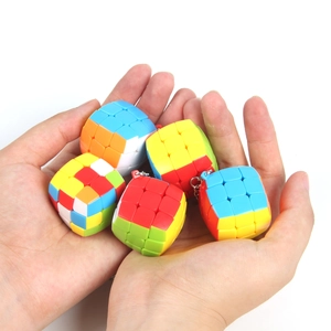 Close-up of 3cm colorful mini cube keychains held in hands with silver metal rings