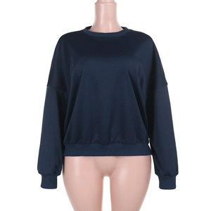 Detail of navy blue crew neck sweatshirt featuring ribbed cuffs and hem on mannequin