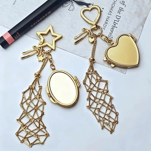 Detailed view of gold star and heart shaped locket keychains with mesh net accents