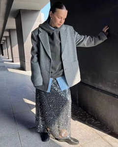 Full body shot of a grey wool blazer styled with a silver sequin maxi skirt in modern street style