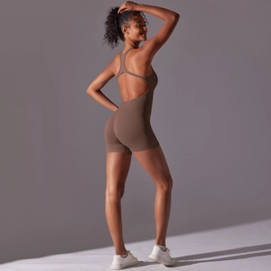 Detailed side view of backless one-piece yoga romper in brown with ribbed knit texture
